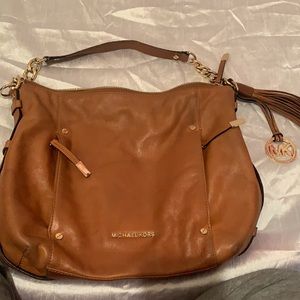 Michael Kors purse. Has two small pockets in the front.